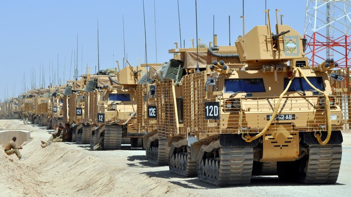 Line of military vehicles in a desert environment
