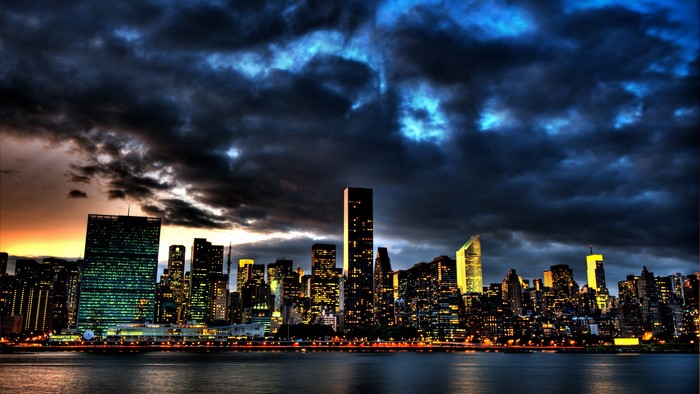 New York City skyline at night with dark clouds