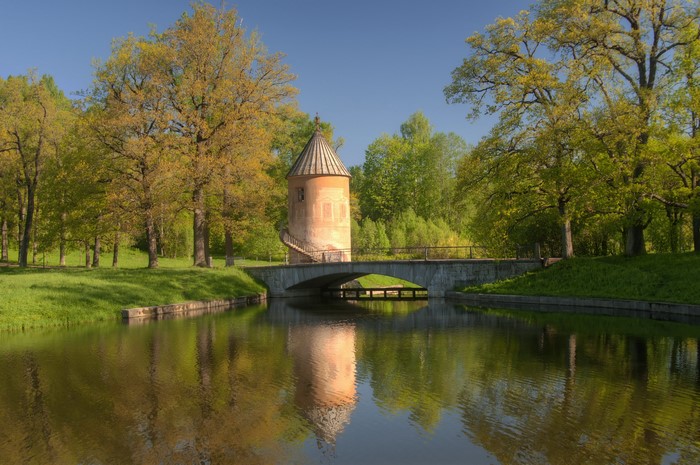 Park with a tower and a bridge over a canal