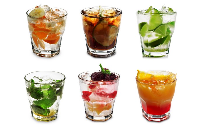 Six glasses of colorful cocktails with fruits and ice