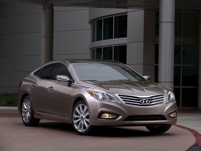 Hyundai Azera sedan parked in front of a modern building