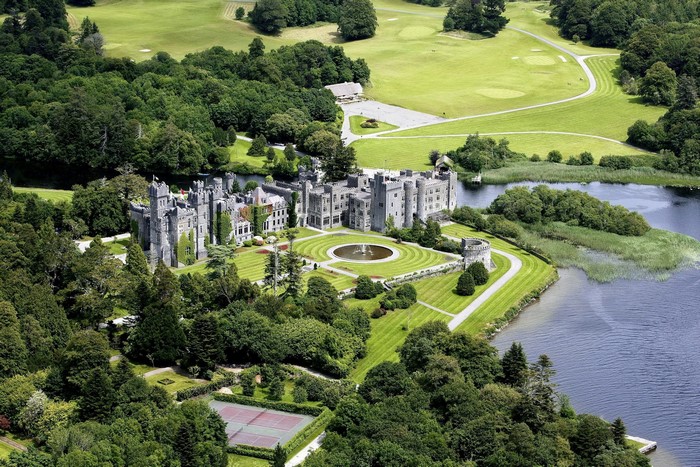 Ashford Castle and its grounds by a lake