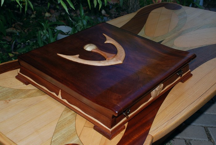 Decorative wooden box with inlay on a marquetry table