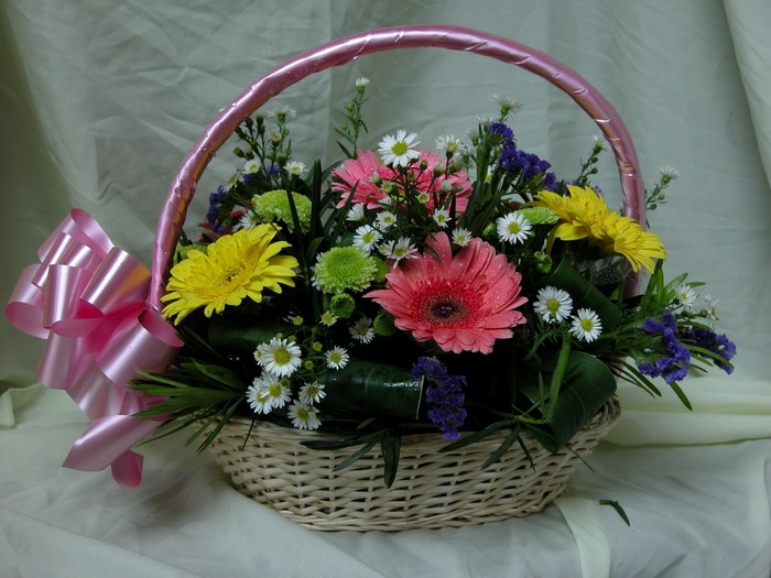 Flower basket with pink bow and assorted flowers
