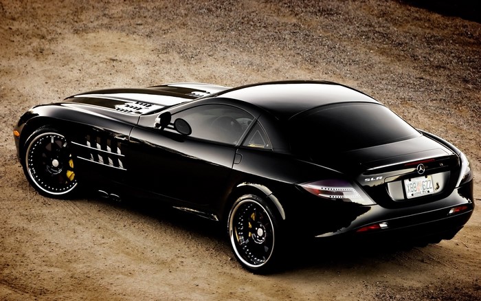 Black Mercedes-Benz SLR McLaren parked on dirt