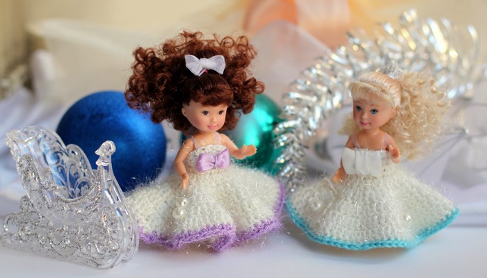 Two dolls in knitted dresses with Christmas decorations