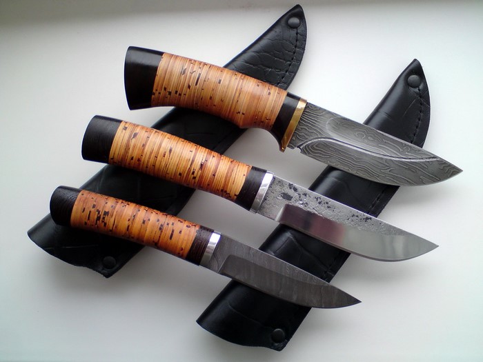 Three knives with leather sheaths