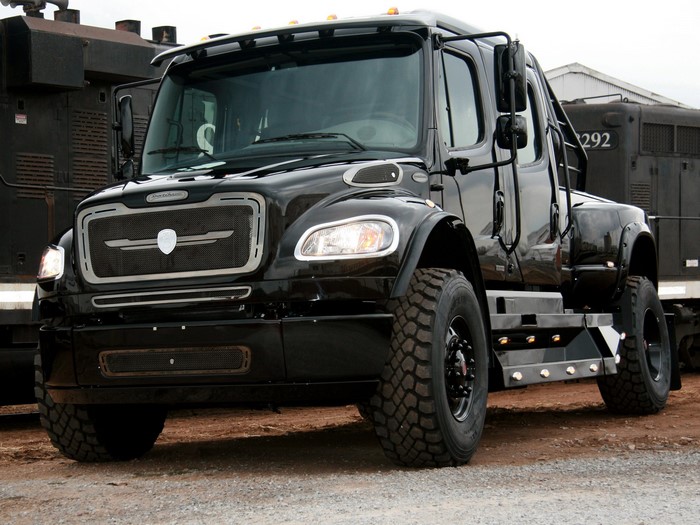 Black Freightliner truck with large tires
