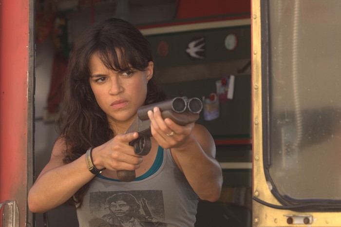 Michelle Rodriguez holding a shotgun