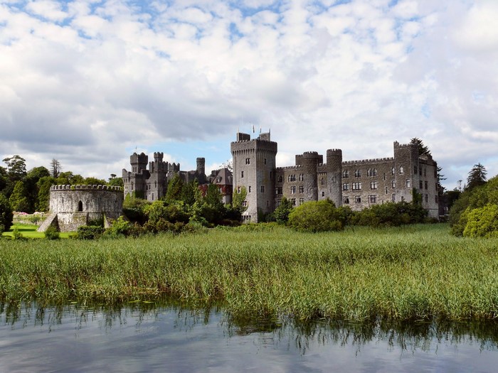 Ashford Castle on a lake with reeds