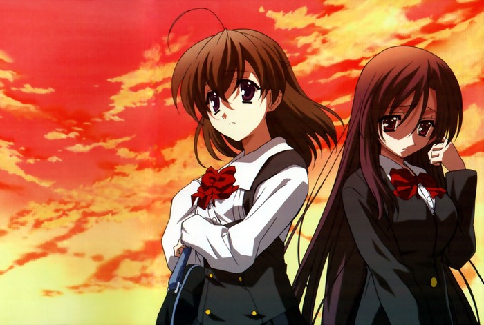 Two schoolgirls against a sunset sky