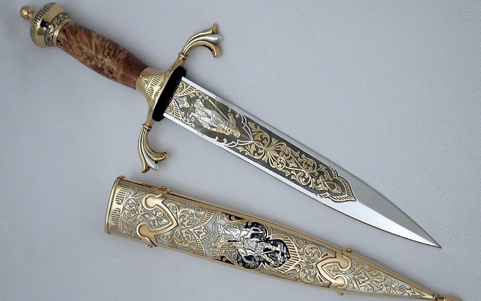 Ornate dagger with engraved blade and scabbard