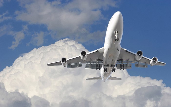 Boeing 747 airplane flying through clouds