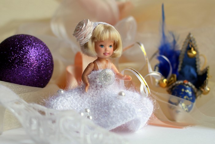 Doll in a white dress with party decorations