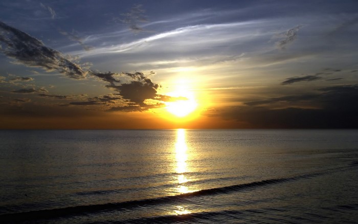 Sunset over the ocean with clouds