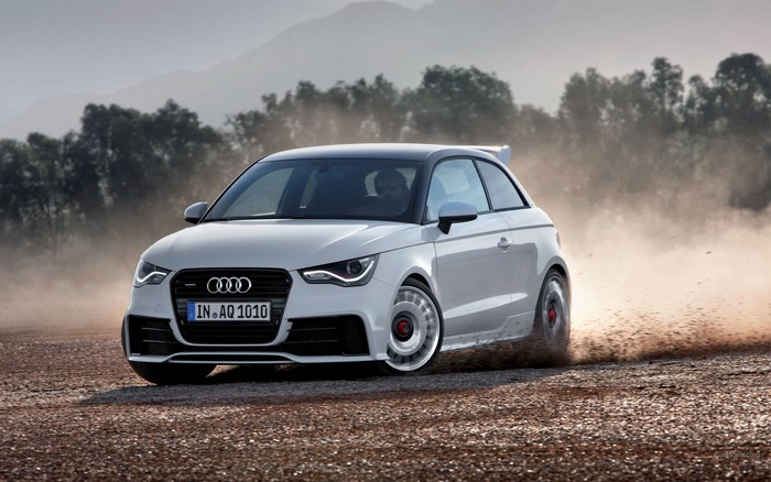 White Audi A1 drifting on a dirt road