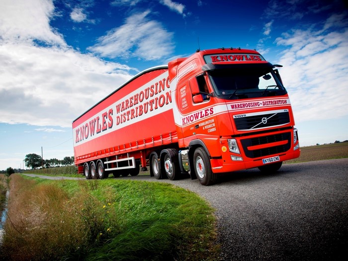 Red Volvo Truck with Knowles Warehousing Distribution Trailer
