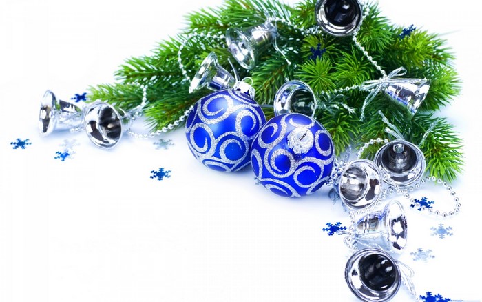Christmas ornaments and pine branches on white background