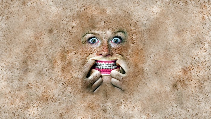 Woman with braces and freckles distorted face