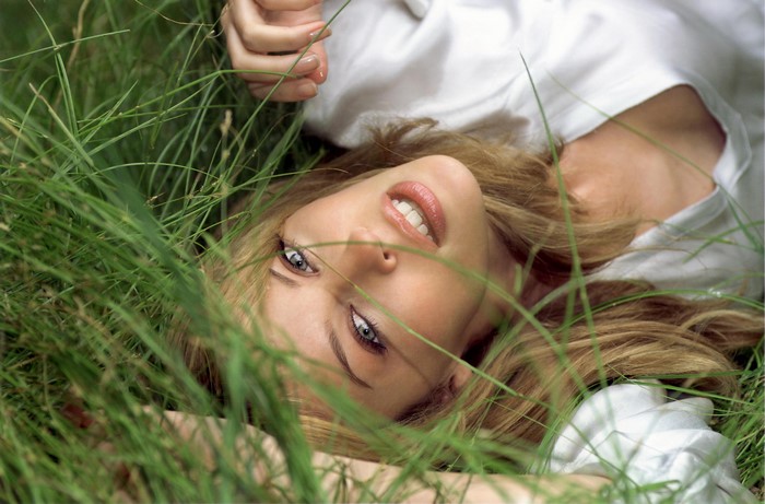 Kylie Minogue lying in grass