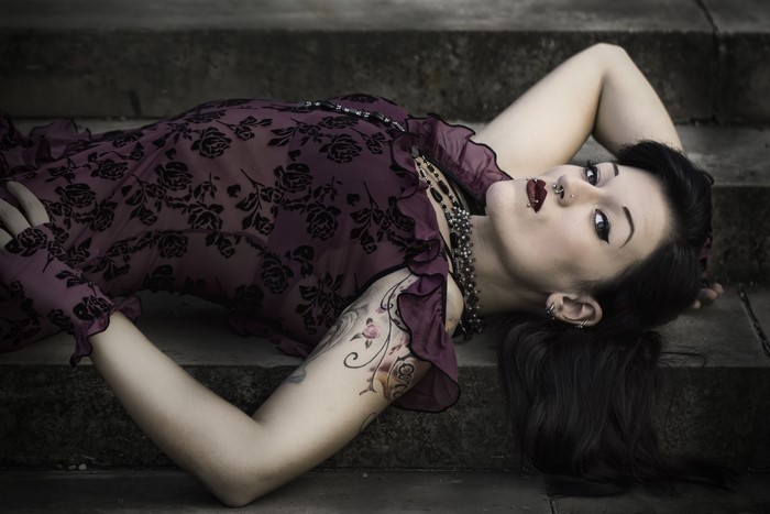 Woman in a floral dress lying on steps