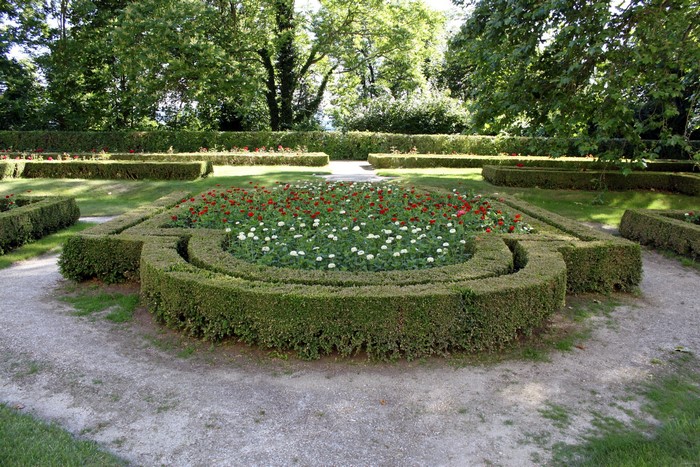 Formal garden with flower beds and manicured hedges