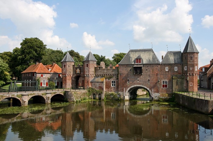 Historic brick gatehouse and bridge over water in Netherlands