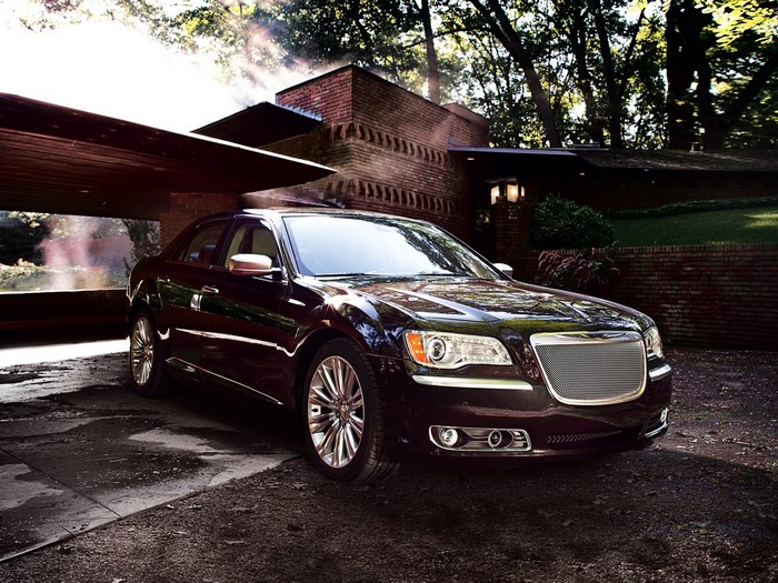 Chrysler 300 sedan parked near a brick house