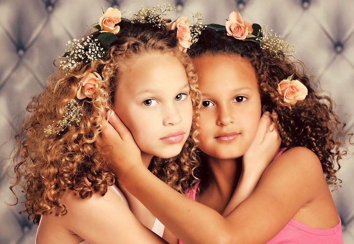Two young girls with flowers in their hair