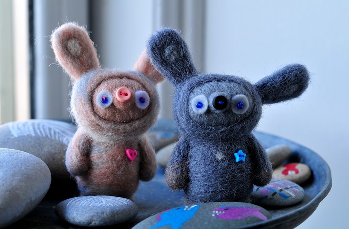 Two needle-felted toys with buttons for eyes