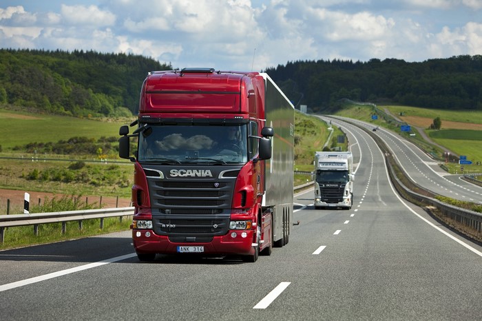 Two Scania trucks on a highway
