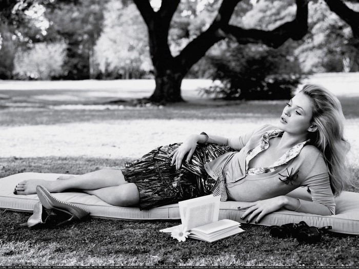 Kate Moss lounging in a park