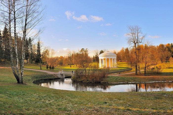 Park with a pond and a rotunda in autumn