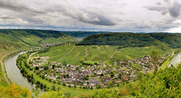 Panoramic view of a village nestled in a river bend with vineyards in Germany