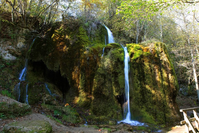 Moss-covered rocks with multiple waterfalls