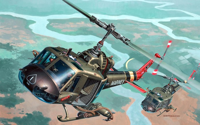 Two US Marine Corps helicopters flying over a river