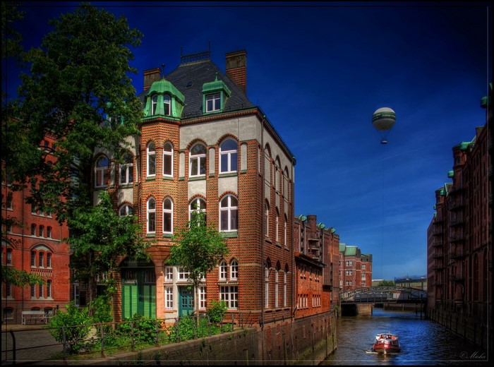 Hamburg, Germany canal with buildings and hot air balloon