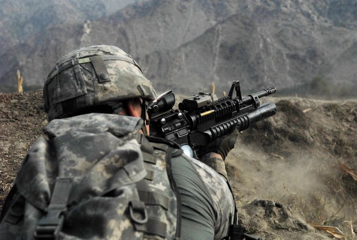 Soldier aiming a rifle with grenade launcher
