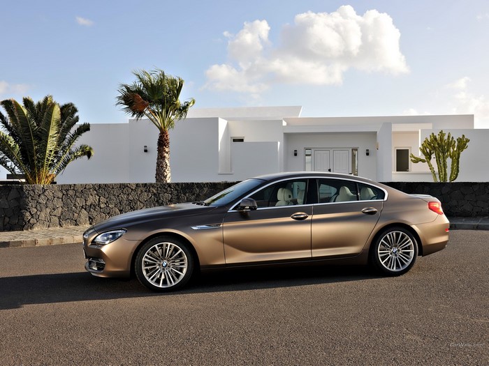 BMW 6 Series Gran Coupe parked in front of a modern white house