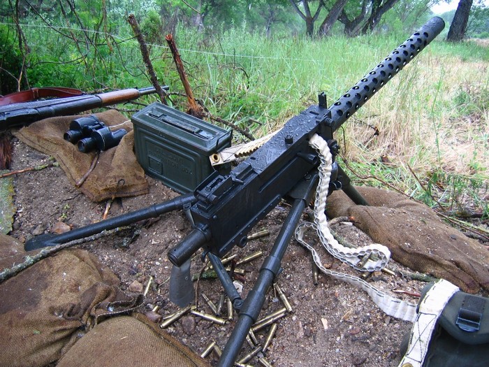 Machine gun with ammunition and supplies in a trench