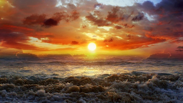 Sunset over the ocean with dramatic clouds