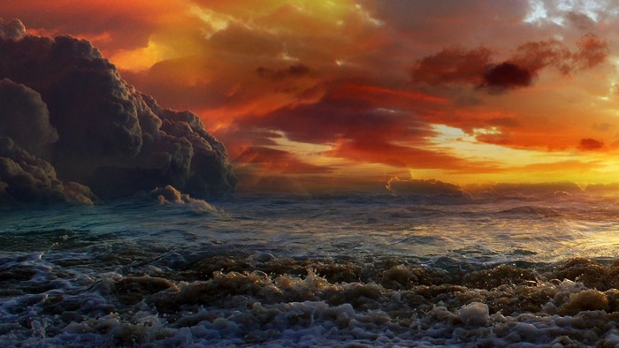 Stormy sunset over rough ocean waves