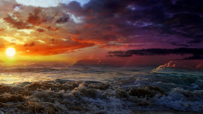 Sunset over stormy ocean waves