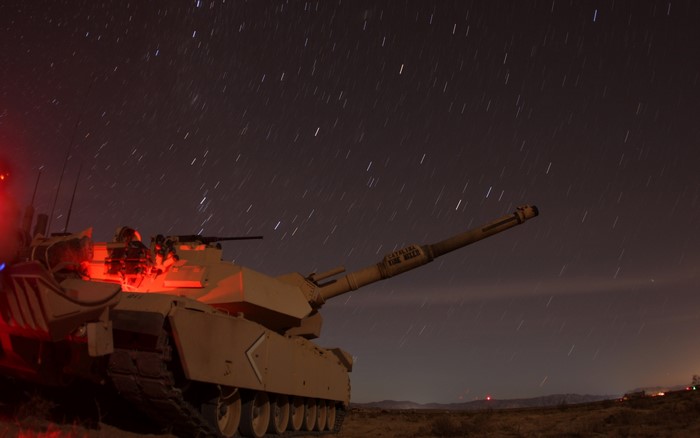 M1 Abrams tank under a starry night sky