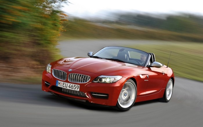 Red BMW Z4 Convertible Driving on a Road