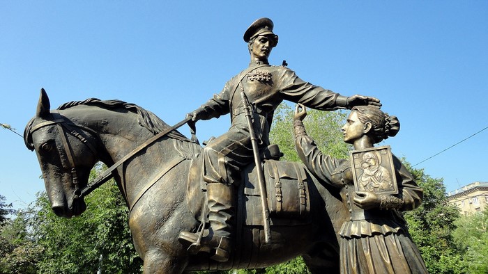 Monument of a soldier on horseback with a woman holding an icon