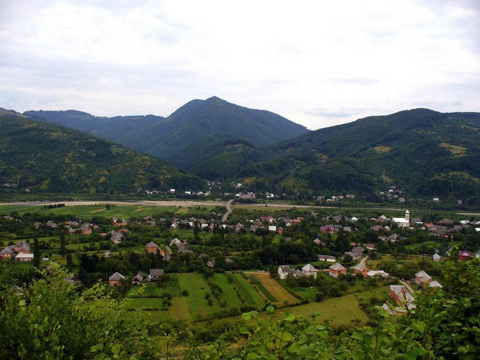 Village nestled in a valley with mountains