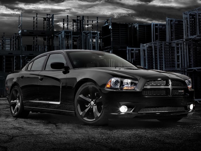 Black Dodge Charger parked in industrial area