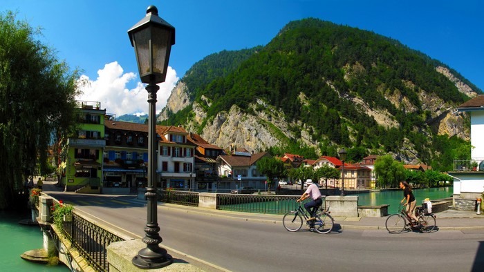 Two cyclists on a bridge in Interlaken, Switzerland