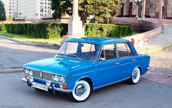 Blue classic Soviet sedan car parked on street